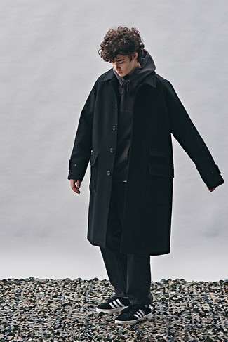 Men's Outfits 2022: This pairing of a black overcoat and black jeans makes for the perfect base for a casually smart ensemble. And if you need to immediately play down this ensemble with footwear, complement your outfit with black and white suede low top sneakers.
