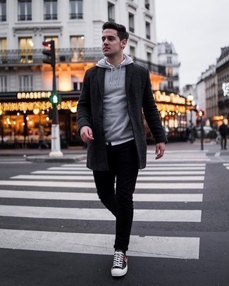 Black Print Canvas Low Top Sneakers Outfits For Men: Pairing a charcoal overcoat with black skinny jeans is an awesome idea for a laid-back and cool outfit. Complete this look with a pair of black print canvas low top sneakers to keep the look fresh.