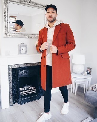 Orange Overcoat Outfits: If you gravitate towards casual outfits, why not rock an orange overcoat with black ripped skinny jeans? When this ensemble appears all-too-polished, tone it down with a pair of white athletic shoes.