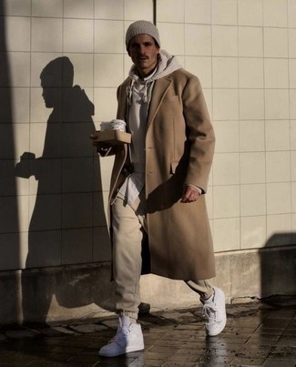Beige Sweatpants Outfits For Men: A camel overcoat and beige sweatpants are a combination that every style-conscious man should have in his casual routine. Rounding off with white leather high top sneakers is a fail-safe way to introduce a carefree touch to this outfit.