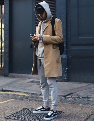 Black Backpack Outfits For Men: Why not wear a camel overcoat with a black backpack? As well as super practical, both of these items look cool when combined together. Our favorite of an infinite number of ways to finish off this outfit is black and white canvas low top sneakers.