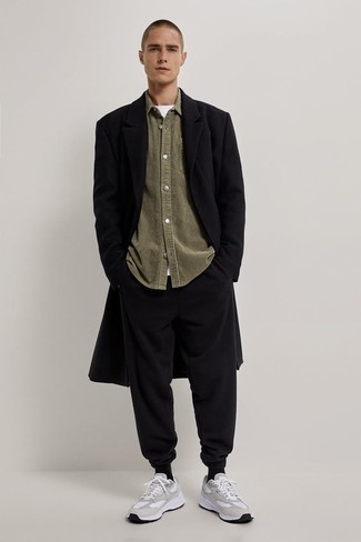 Men's Outfits 2022: This relaxed pairing of a black overcoat and black sweatpants is capable of taking on different nuances depending on the way it's styled. And it's amazing what grey athletic shoes can do for the ensemble.