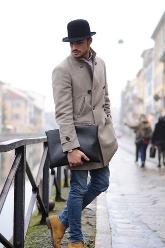 Black Hat Outfits For Men: One of the best ways for a man to style out a grey overcoat is to team it with a black hat in a laid-back getup. For something more on the classier side to complement this outfit, introduce tan suede casual boots to the equation.