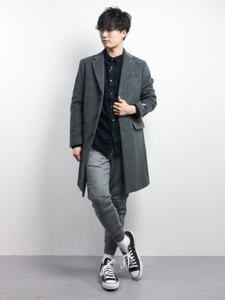 Black and White Canvas Low Top Sneakers Outfits For Men: This getup with a charcoal overcoat and grey sweatpants isn't hard to pull off and is easy to change throughout the day. If you wish to immediately dress down your look with a pair of shoes, introduce a pair of black and white canvas low top sneakers to the equation.
