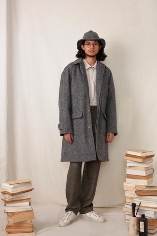 Grey Herringbone Overcoat Outfits: Go for a pared down but refined ensemble pairing a grey herringbone overcoat and dark brown wool chinos. To give your outfit a more casual touch, why not complete this look with a pair of white canvas low top sneakers?