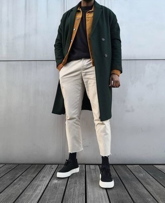 Black Canvas Low Top Sneakers Outfits For Men: If you don't take fashion lightly, go for sophisticated style in a dark green overcoat and beige jeans. You can go down a more casual route when it comes to footwear by wearing a pair of black canvas low top sneakers.