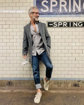 Grey Overcoat Outfits: This combo of a grey overcoat and navy jeans falls somewhere between formal and off-duty. Got bored with this outfit? Enter a pair of white leather low top sneakers to switch things up.