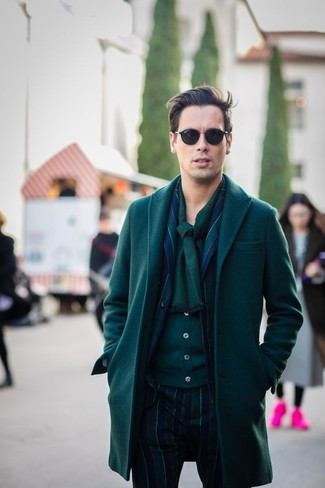 Olive Cardigan Cold Weather Outfits For Men: We're loving the way this smart combo of an olive cardigan and a dark green overcoat immediately makes men look seriously stylish.