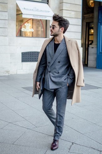 Beige Coat Outfits For Men: This refined combo of a beige coat and a blue suit will allow you to assert your styling skills. Make your ensemble a bit more elegant by rounding off with burgundy leather derby shoes.