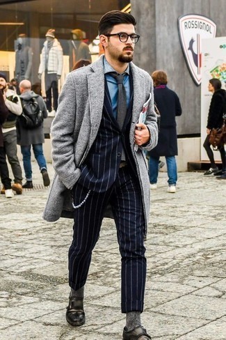 Charcoal Leather Monks Outfits: This classy combo of a grey overcoat and a navy vertical striped suit will hallmark your sartorial chops. Charcoal leather monks tie the look together.