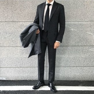 Grey Wool Suit Fall Outfits: A grey wool suit looks so elegant when married with a grey overcoat in a modern man's ensemble. Want to go easy on the shoe front? Add a pair of black leather derby shoes to the mix for the day. This one is a viable idea if you're putting together a cool summer-to-fall look.
