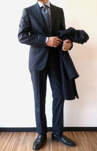 Navy Suit Outfits: Putting together a navy suit and a navy houndstooth overcoat is a fail-safe way to infuse personality into your current arsenal. Complement this outfit with black leather loafers for extra style points.