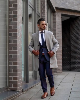 Brown Leather Brogues Outfits: This pairing of a grey overcoat and a navy suit can only be described as devastatingly dapper and classy. To infuse an easy-going vibe into this outfit, introduce brown leather brogues to your look.