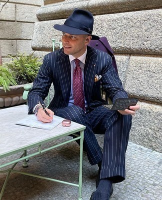 1200+ Cold Weather Outfits For Men: Putting together a violet overcoat with a navy vertical striped suit is a wonderful idea for a smart and classy getup. Complement this outfit with black leather loafers et voila, this look is complete.