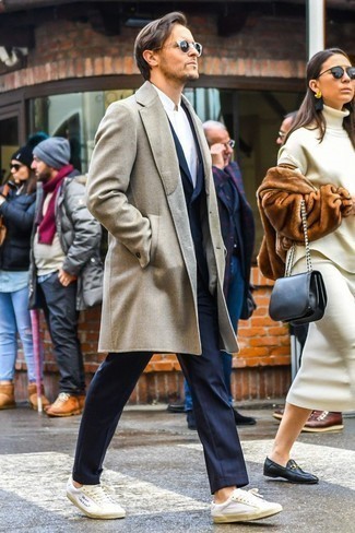 Black Sunglasses Cold Weather Outfits For Men: A beige overcoat and black sunglasses are an off-duty pairing that every fashion-savvy gentleman should have in his closet. When in doubt about the footwear, introduce a pair of white leather low top sneakers to this getup.