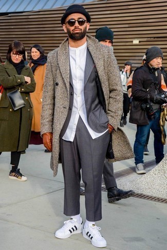 Dark Brown Herringbone Overcoat Outfits: A dark brown herringbone overcoat and a grey vertical striped suit are absolute staples if you're planning a smart wardrobe that holds to the highest men's style standards. For a more laid-back take, why not add white and black leather low top sneakers to the mix?
