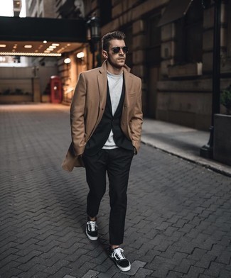 Black Sunglasses Smart Casual Outfits For Men: This combination of a camel overcoat and black sunglasses is on the off-duty side yet it's also seriously stylish and incredibly dapper. Look at how great this look is finished off with a pair of black and white canvas low top sneakers.