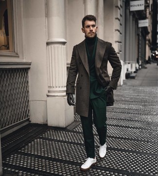Dark Green Suit Outfits: This pairing of a dark green suit and a dark brown overcoat is a real lifesaver when you need to look truly dapper. In the footwear department, go for something on the laid-back end of the spectrum and finish off this ensemble with a pair of white leather low top sneakers.