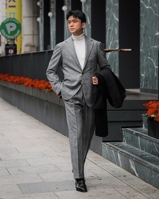 White Turtleneck Outfits For Men: A white turtleneck and a black overcoat worn together are the ideal getup for those who love casually neat outfits. Don't know how to round off this ensemble? Wear a pair of black leather loafers to rev up the classy factor.