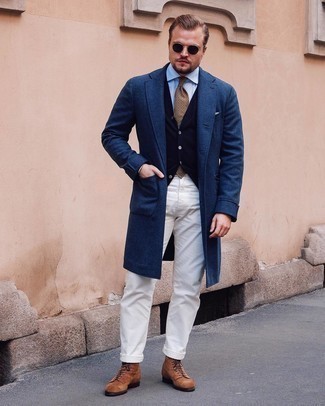 Navy Sweater Vest Outfits For Men: A navy sweater vest and white chinos are an easy way to inject some sophistication into your day-to-day routine. Brown suede casual boots pull the ensemble together.