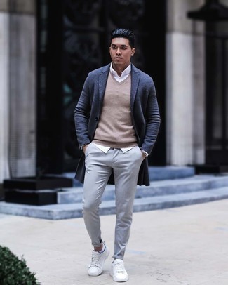 Beige Sweater Vest Outfits For Men: A beige sweater vest and grey chinos married together are a match made in heaven for those who appreciate casually classy styles. Want to break out of the mold? Then why not complement your getup with a pair of white canvas low top sneakers?