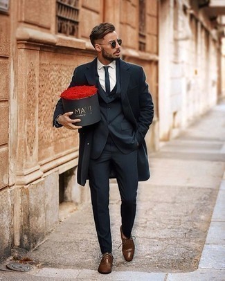 Navy Overcoat Outfits: When it comes to high-octane elegance, this pairing of a navy overcoat and a navy three piece suit doesn't disappoint. Wondering how to round off? Complement this ensemble with a pair of brown leather derby shoes to spice things up.