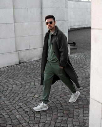 Track Suit Outfits For Men: Try pairing a track suit with a dark green overcoat to put together an interesting and current laid-back ensemble. Grey athletic shoes are guaranteed to give a dash of stylish casualness to this look.