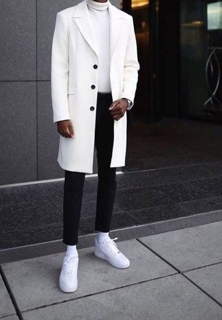 Black Chinos Smart Casual Outfits: Reach for a white overcoat and black chinos if you're going for a proper, sharp look. Feeling brave today? Break up this ensemble by finishing with a pair of white leather low top sneakers.