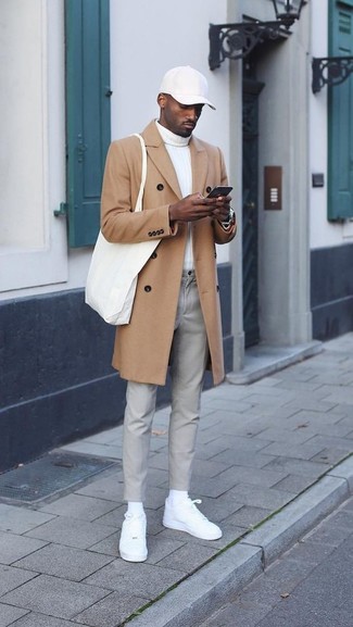 White and Red Baseball Cap Outfits For Men: Try teaming a camel overcoat with a white and red baseball cap for an outfit that's both modern casual and practical. We're totally digging how cohesive this outfit looks when completed with a pair of white leather low top sneakers.