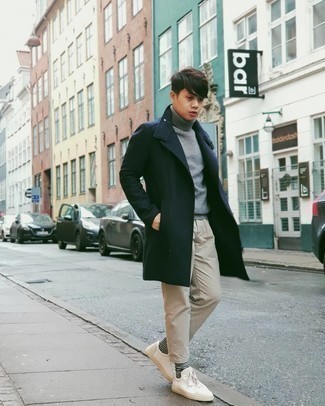 Navy Overcoat Outfits: For a look that's worthy of a modern sartorially savvy guy and casually classic, dress in a navy overcoat and beige chinos. Dial down the formality of your outfit by rocking a pair of white canvas low top sneakers.