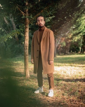 Camel Overcoat Outfits: This smart pairing of a camel overcoat and brown chinos is super easy to put together without a second thought, helping you look awesome and prepared for anything without spending too much time going through your wardrobe. And it's amazing how white athletic shoes can update an ensemble.