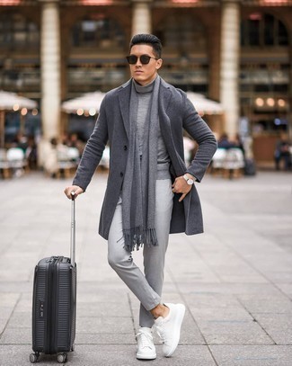 Black Suitcase Outfits For Men: Try pairing a charcoal overcoat with a black suitcase for a stylish and urban outfit. If you're not sure how to finish off, a pair of white leather low top sneakers is a winning option.