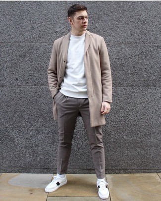 White and Black Leather Shoes with Pants Outfits For Men: This smart casual combination of a camel overcoat and pants is super easy to pull together without a second thought, helping you look on-trend and ready for anything without spending too much time searching through your wardrobe. White and black leather low top sneakers integrate seamlessly within plenty of combos.