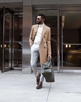 Dark Green Leather Duffle Bag Outfits For Men: One of the best ways for a man to style a camel overcoat is to wear it with a dark green leather duffle bag for a casual look. When it comes to footwear, go for something on the classier end of the spectrum by slipping into dark brown leather tassel loafers.