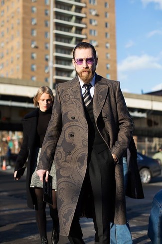 One of the classiest ways to style out such a timeless menswear item as a dark brown paisley overcoat is to combine it with black dress pants.