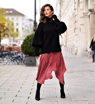Black Elastic Ankle Boots Smart Casual Outfits: Stylish yet practical, this outfit is assembled from a black knit oversized sweater and a red polka dot midi dress. Throw black elastic ankle boots in the mix to switch things up.