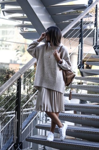 Grey Midi Skirt Outfits: If the setting allows a relaxed casual outfit, you can easily go for a grey oversized sweater and a grey midi skirt. With footwear, go for something on the laid-back end of the spectrum and round off your ensemble with white low top sneakers.