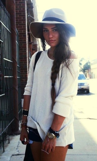 Blue Ripped Denim Shorts Outfits For Women: A white oversized sweater and blue ripped denim shorts are a good pairing to keep in your closet.