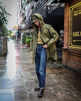 1200+ Cold Weather Outfits For Men: The combination of an olive raincoat and navy jeans makes this a solid off-duty outfit. If you want to easily up the ante of this outfit with a pair of shoes, complete your look with a pair of black leather chelsea boots.