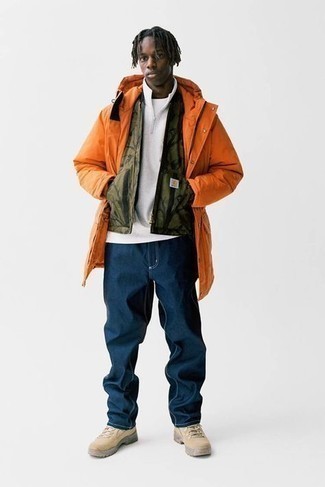 Orange Parka Outfits For Men: You're looking at the irrefutable proof that an orange parka and navy jeans look amazing when worn together in a casual ensemble. Beige suede work boots will add a fun touch to this outfit.