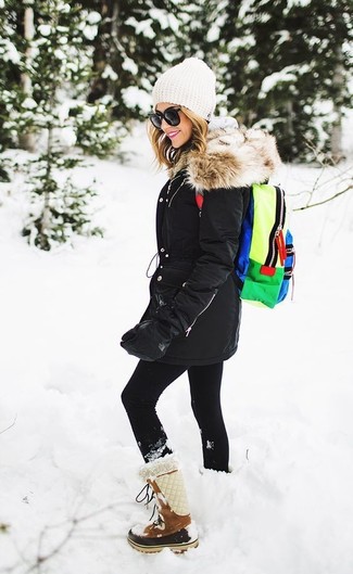 Snow Boots Outfits For Women: For an on-trend outfit without the need to sacrifice on comfort, we like this laid-back pairing of a black parka and black leggings. If in doubt as to the footwear, go with a pair of snow boots.