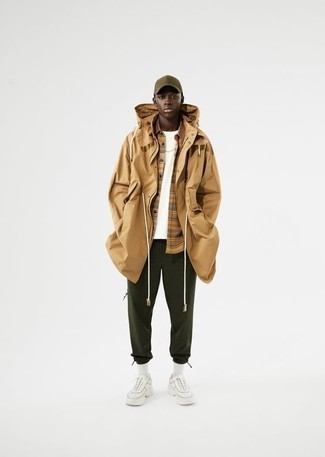 500+ Chill Weather Outfits For Men: For an off-duty getup, team a tan lightweight parka with dark green sweatpants — these items fit really good together. Complement your outfit with white athletic shoes to tie your full look together.