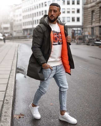 Dark Green Parka Outfits For Men: Such essentials as a dark green parka and light blue ripped skinny jeans are an easy way to introduce effortless cool into your casual fashion mix. White canvas low top sneakers will immediately class up even your most comfortable clothes.