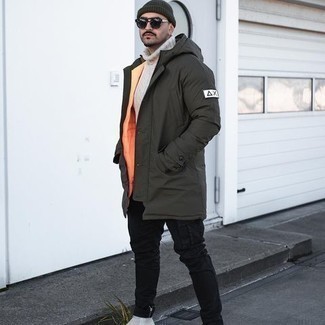 Dark Green Parka Outfits For Men: This edgy combination of a dark green parka and black cargo pants can only be described as devastatingly dapper. Ramp up the dressiness of this outfit a bit by finishing off with a pair of grey suede chelsea boots.