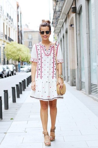 Tan Leather Wedge Sandals Outfits: Opt for a white embroidered peasant dress for an off-duty and trendy look. On the fence about how to finish off? Enter a pair of tan leather wedge sandals into the equation to amp up the chic factor.