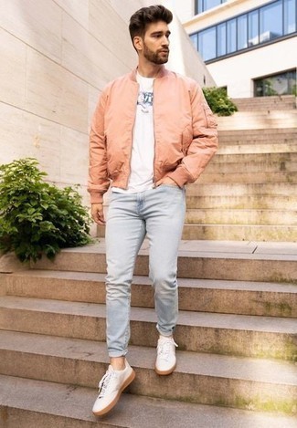 Pink Bomber Jacket Outfits For Men: This laid-back pairing of a pink bomber jacket and light blue jeans is extremely easy to throw together without a second thought, helping you look sharp and prepared for anything without spending too much time digging through your closet. All you need now is a pair of white canvas low top sneakers to complete this ensemble.
