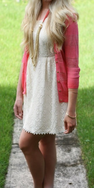 For a casually edgy outfit, wear a pink cardigan and a beige lace skater dress — these two pieces play really well together.
