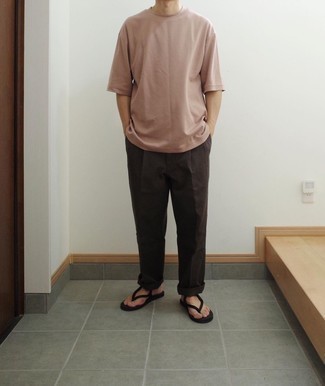 Black Flip Flops Outfits For Men: For a casual and cool ensemble, team a pink crew-neck t-shirt with dark brown chinos — these items go really well together. Feel somewhat uninspired with this getup? Let a pair of black flip flops spice things up.