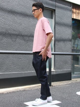 Pink Crew-neck T-shirt with Blue Jeans Summer Outfits For Men: This pairing of a pink crew-neck t-shirt and blue jeans is hard proof that a safe casual ensemble doesn't have to be boring. Now all you need is a nice pair of white canvas low top sneakers. This look is a fail-safe option if you're looking for a great, season-appropriate look.