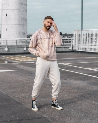 White Sweatpants Outfits For Men: Team a pink print sweatshirt with white sweatpants to put together an urban and comfortable getup. Complete your getup with a pair of black and white canvas high top sneakers and you're all done and looking amazing.